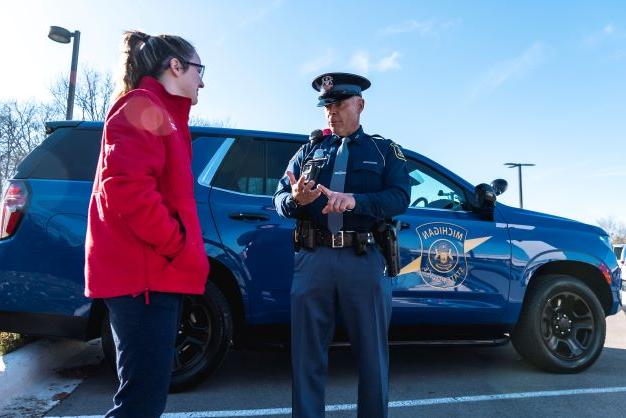 Mich. state police officer with student.